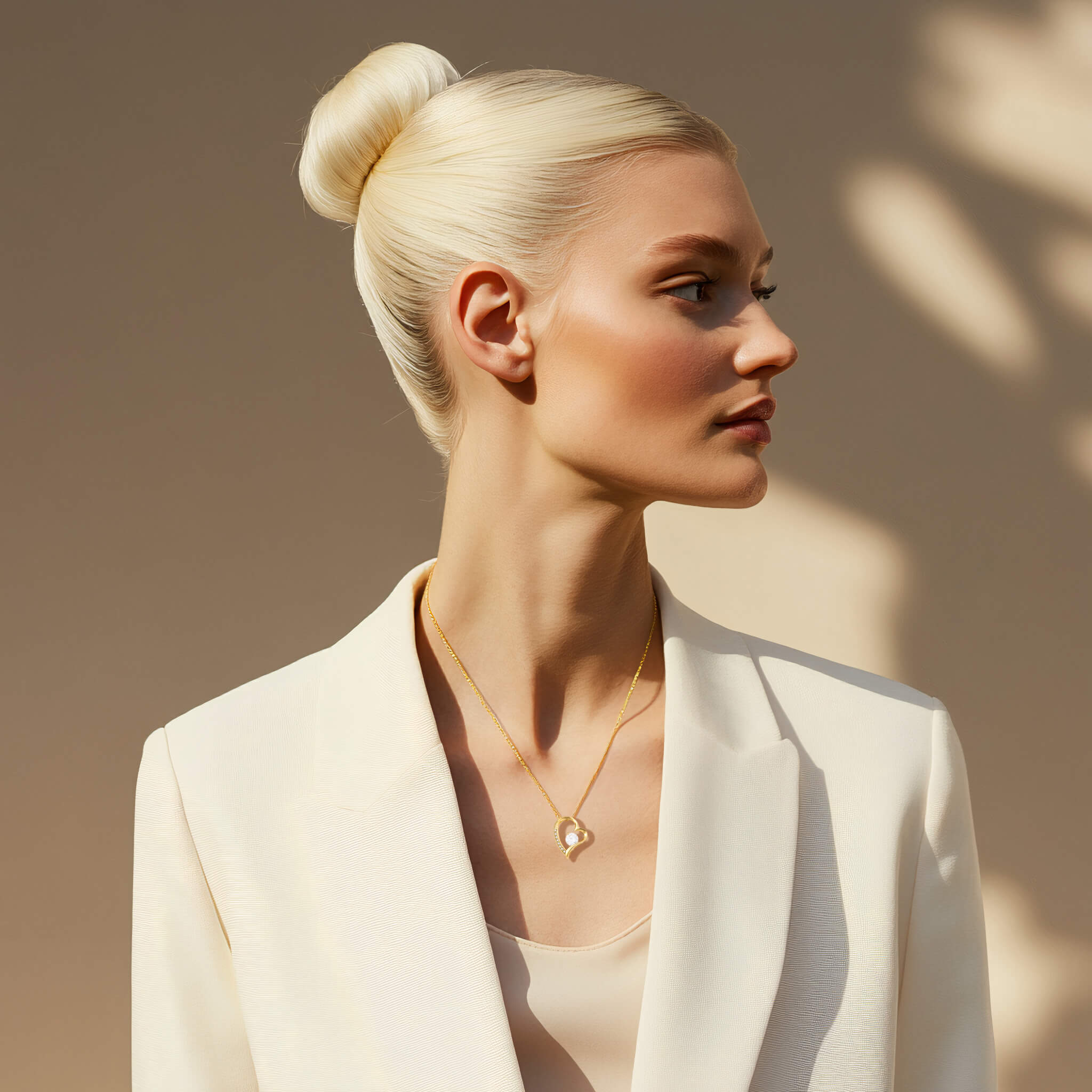 Businesswoman wearing gold heart-shaped necklace with center crystal 