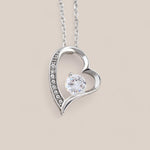 14k white gold-plated Passion necklace featuring an asymmetrical heart-shaped design with embedded crystals along the side of the heart and a round-cut cubic zirconia crystal in the center.