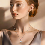 Model wearing the Prosperity necklace with a taupe-colored evening gown in soft natural light.