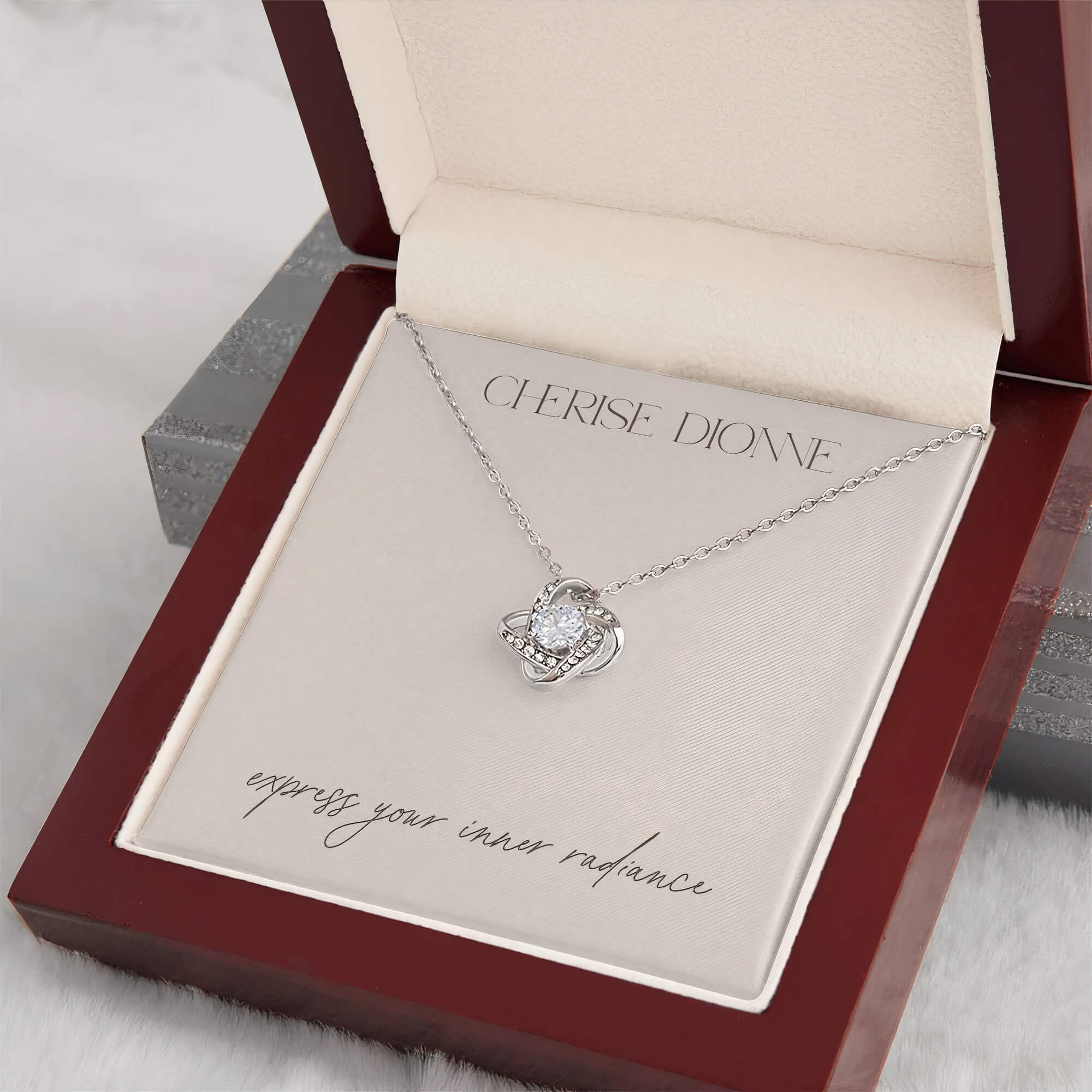 14k gold-plated Radiance necklace packaged in an elegant gift box with a card that features the Cherise Dionne logo and the phrase 'express your inner radiance'.